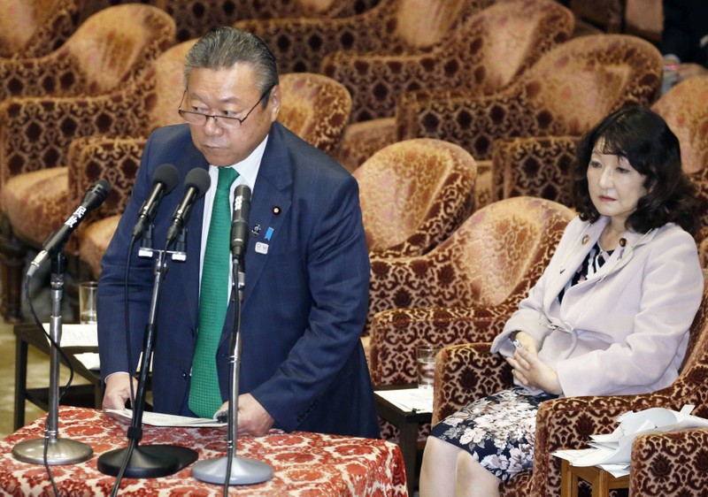 Japan's Olympics and cybersecurity Minister Yoshitaka Sakurada, flanked by minister in charge of local economic revitalisation and female empowerment Satsuki Katayama attend at the lower house parliamentary session in Tokyo