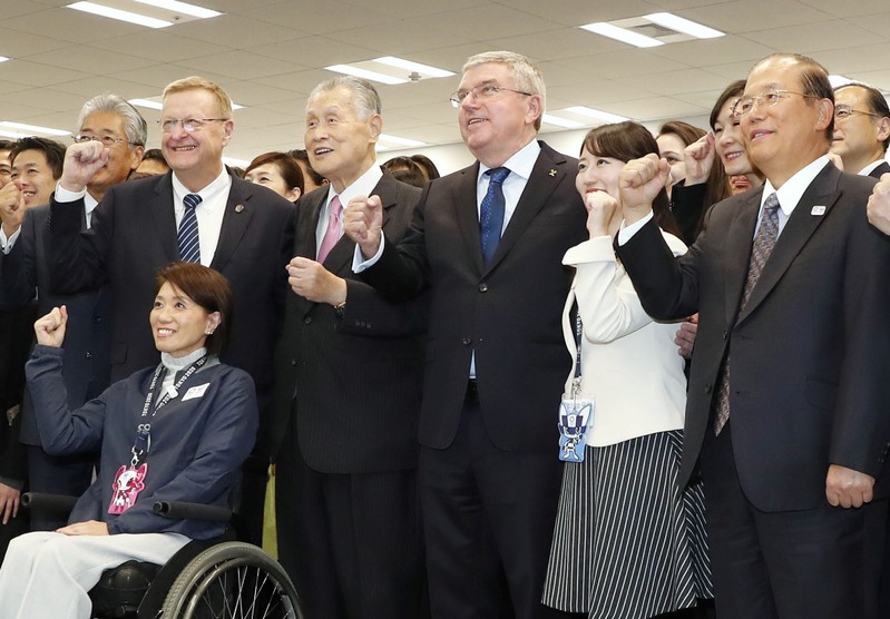 FILE PHOTO: IOC President Thomas Bach poses for a group photo session with Yoshiro Mori, President of Tokyo 2020 Olympic Committee, and other staff members in Tokyo