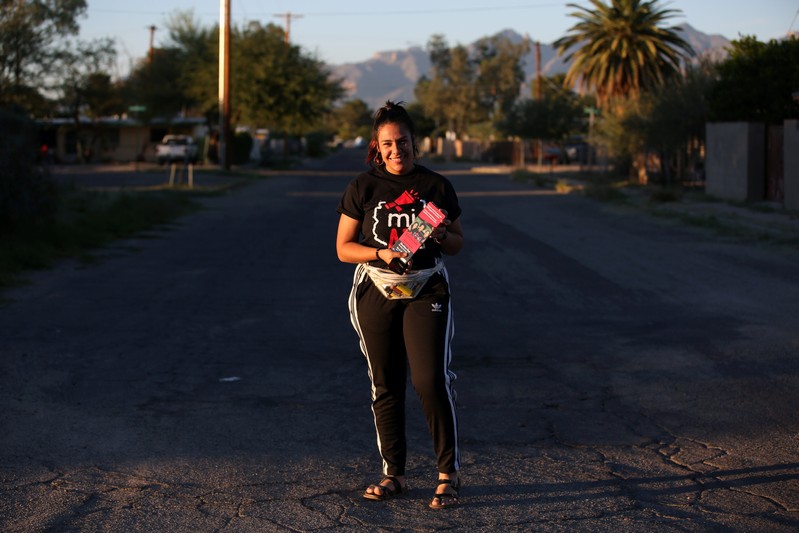 Volunteer Bea Nevarez stands for a portrait during door-to-door canvassing in Tucson, Arizona