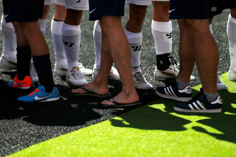 FILE PHOTO: Players of Norway and Scotland greet before their soccer match at the 12th Homeless World Cup soccer tournament in Santiago October 19, 2014