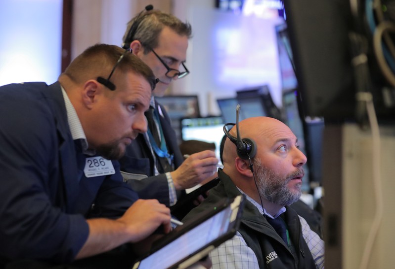 Traders work on the floor at the New York Stock Exchange (NYSE) in New York City