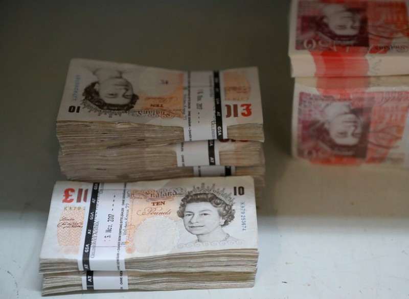 Wads of British Pound Sterling banknotes are stacked in piles at the Money Service Austria company's headquarters in Vienna