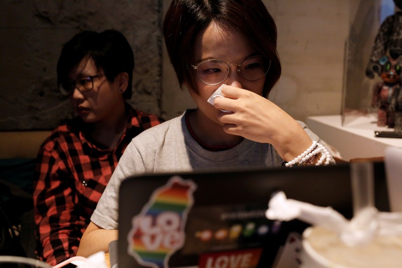 LGBT supporters cry after losing the referendum in Taipei