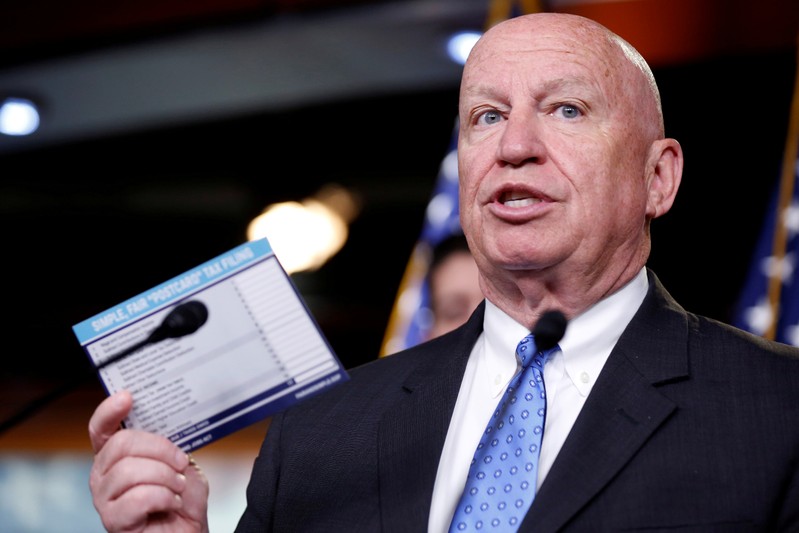 FILE PHOTO: Chairman of the House Ways and Means Committee Brady (R-TX) holds up a sample tax form as he speaks during a media briefing in Washington