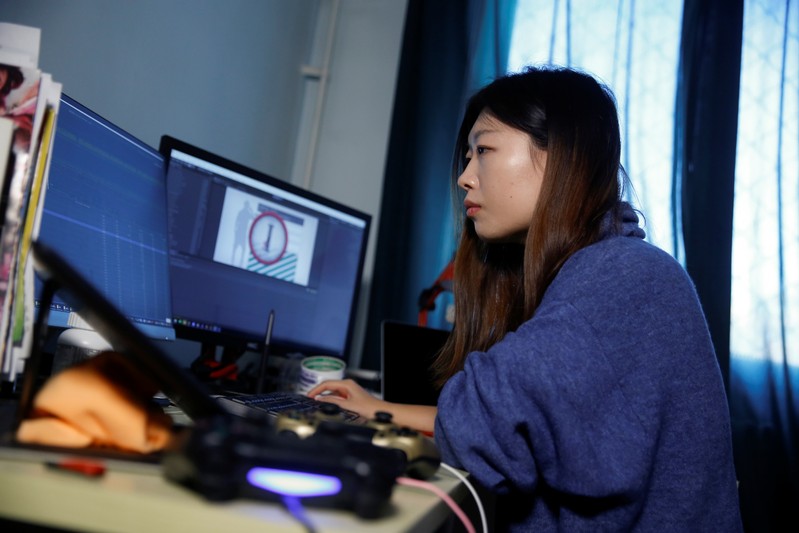 Game developer Wang Miaoyi works in her studio that is located in her appartment in Beijing