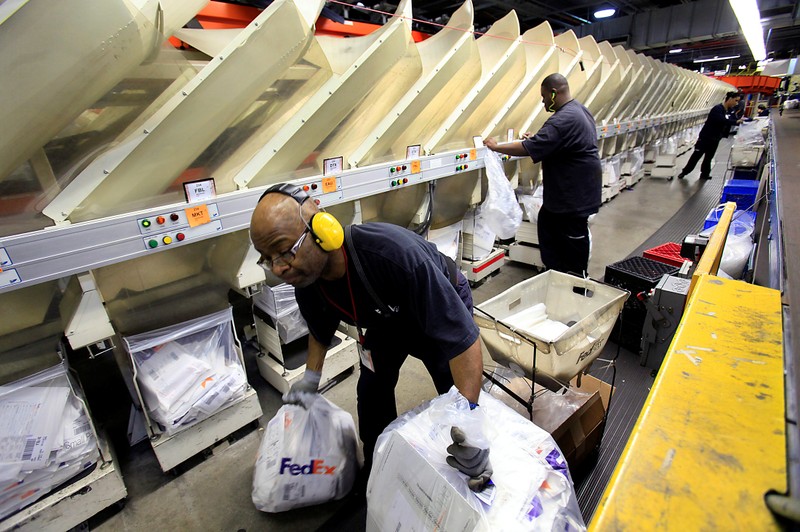 FILE PHOTO: FedEx employees sort packages in the company's small package sorting system at the Memphis World Hub in Memphis