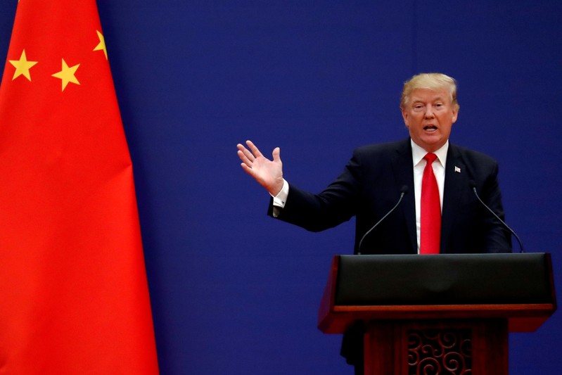 FILE PHOTO: U.S. President Donald Trump delivers his speech as he and China's President Xi Jinping meet business leaders at the Great Hall of the People in Beijing