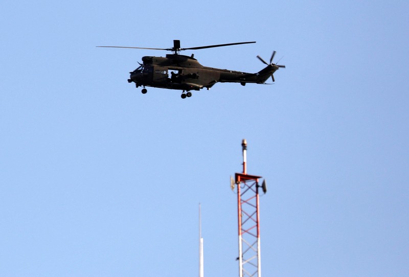 A NATO helicopter flies over the Resolute Support headquarters in Kabul