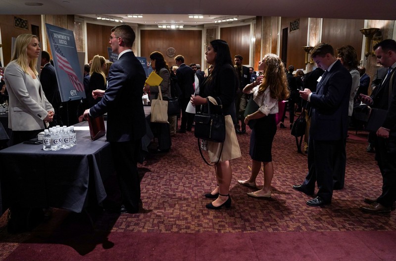 People wait in line at a stand during the Executive Branch Job Fair hosted by the Conservative Partnership Institute at the Dirksen Senate Office Building in Washington