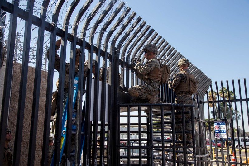 U.S. Marines prepare to place concertina wire at the Otay Mesa Port of Entry in San Diego