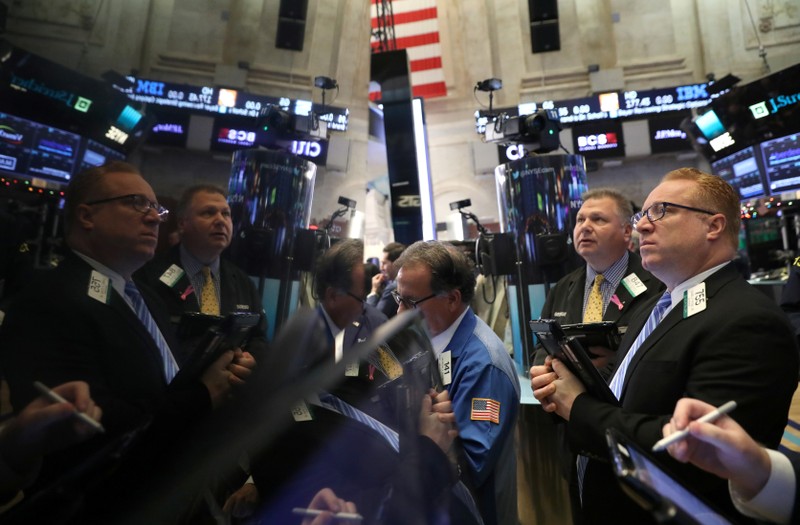 Traders work on the floor of the NYSE in New York