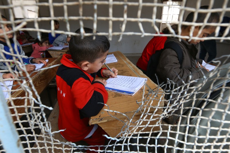 A school child attends a class in Raqqa