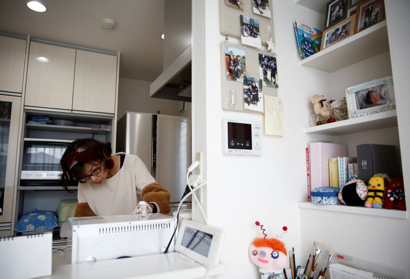 Kanako Hagiwara works in kitchen of her house at Higashinohara district in Inzai