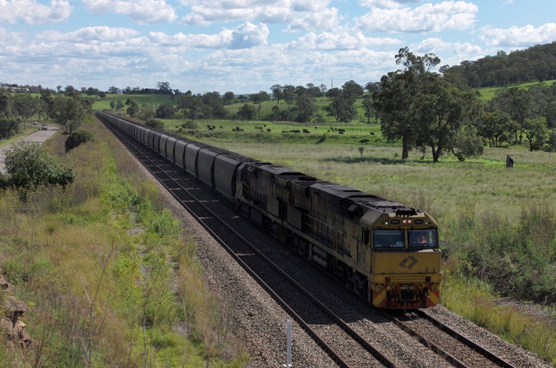 FILE PHOTO - An Aurizon coal train travels through the countryside in Muswellbrook, north of Sydney, Australia