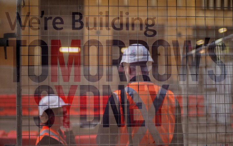 FILE PHOTO - Construction workers on Sydney's light rail infrastructure project are pictured behind a banner in Australia