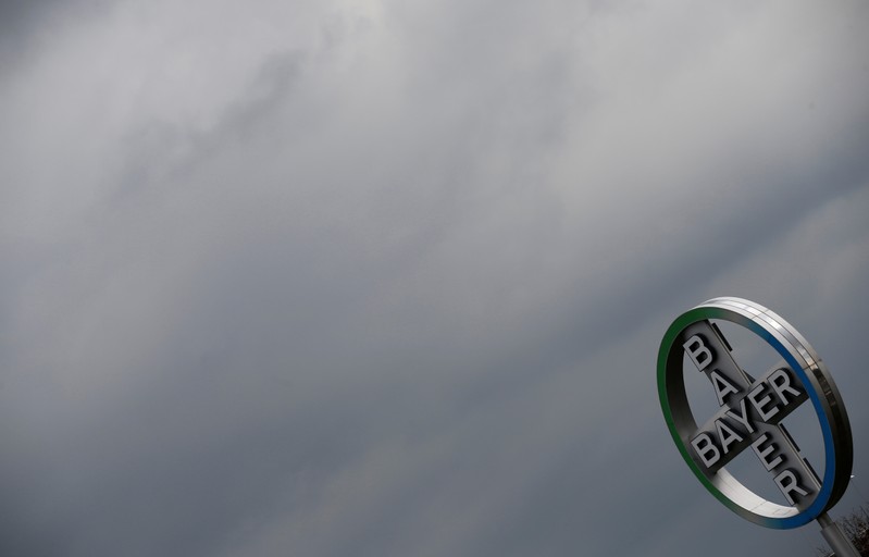 FILE PHOTO: A logo of Bayer is seen next to dark clouds at Cologne Bonn airport