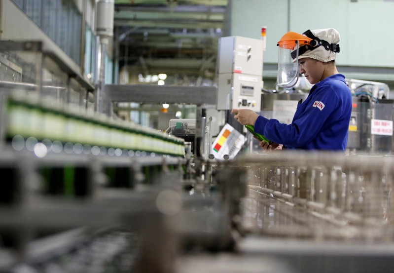 FILE PHOTO - Employee works at Japanese brewer Kirin Holdings' factory in Toride