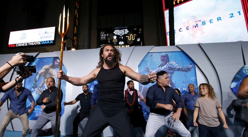 Cast member Momoa performs a haka dance at the premiere for 