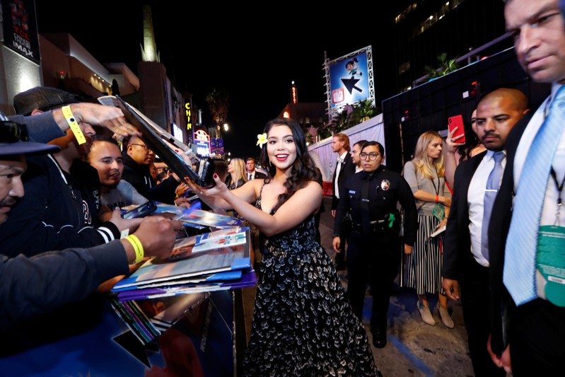 Cast member Cravalho signs autographs at the premiere for the movie 