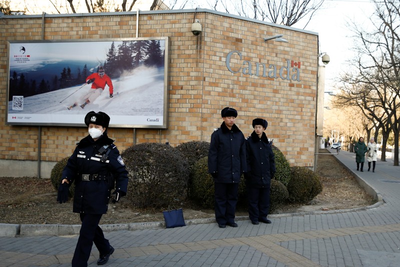 Police keep watch outside Canada Embassy in Beijing