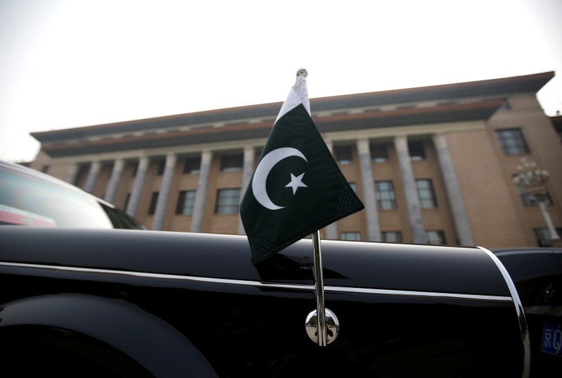 A car with a Pakistani flag waits for Pakistani Minister Imran Khan during his visit in Beijing
