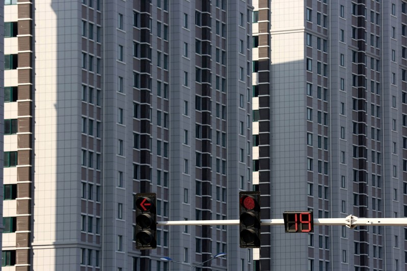 Traffic lights are seen in front of residential buildings in Huaian, Jiangsu