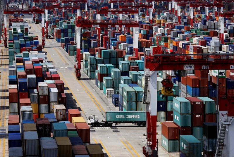 FILE PHOTO - A container truck drives in the container area at the Yangshan Deep Water Port, part of the newly announced Shanghai Free Trade Zone, south of Shanghai