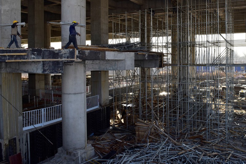 Workers are seen at a construction site of the Zhangjiakou South railway station in Hebei