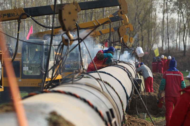 Workers lay pipelines for China National Petroleum Corp (CNPC)'s Shaanxi-Beijing natural gas pipeline network in Hebei