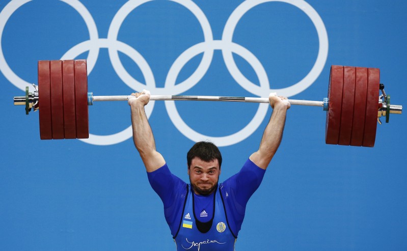 Ukraine's Oleksiy Torokhtiy wins gold as he performs a successful lift in the men's 105kg Group A weightlifting clean and jerk competition during the London 2012 Olympic Games