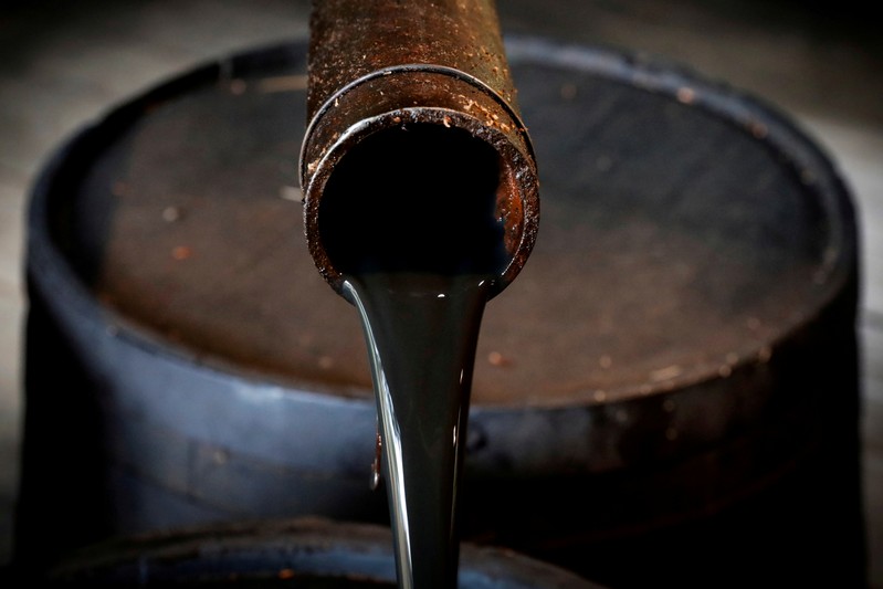 FILE PHOTO: Oil pours out of a spout from Edwin Drake's original 1859 well that launched the modern petroleum industry at the Drake Well Museum and Park in Titusville, Pennsylvania