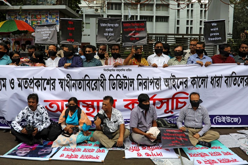 FILE PHOTO: Journalists hold banners and placards as they protest against the newly passed Digital Security Act in front of the Press Club in Dhaka