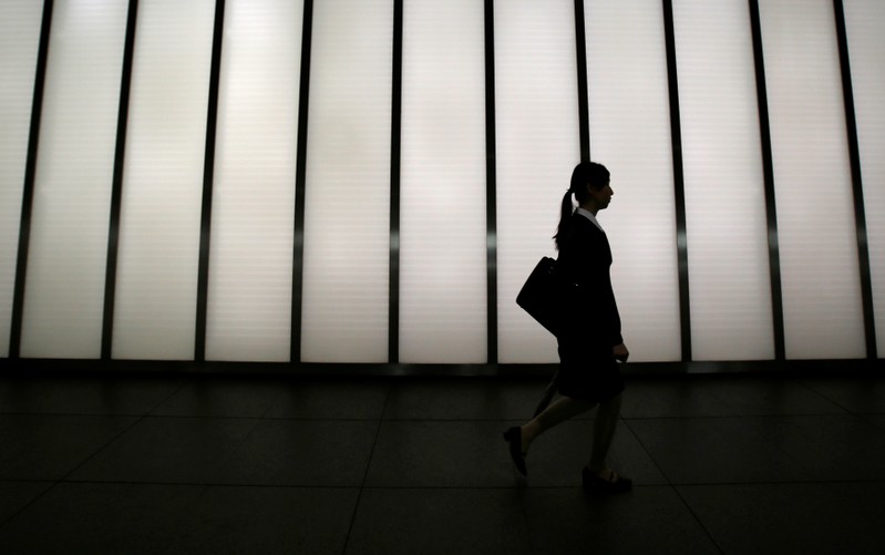 FILE PHOTO: A job seeker walks past a corridor of a commercial building in Tokyo