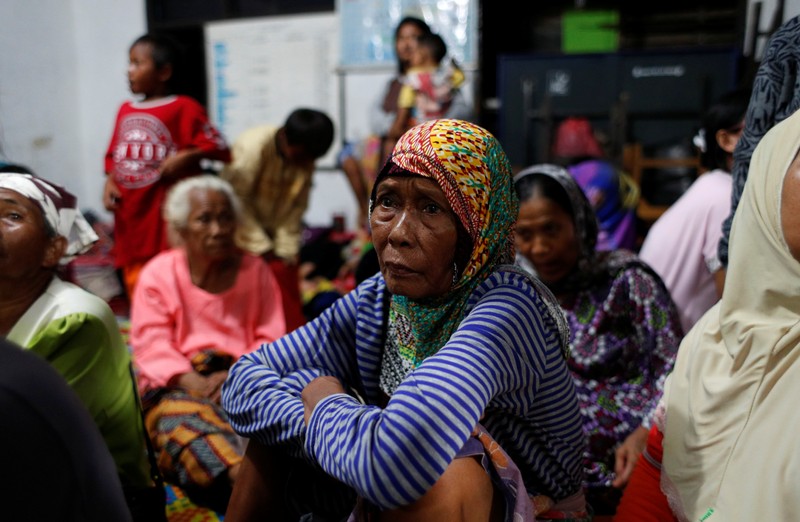 People rest at an evacuation centre at Sidamukti town hall after a tsunami hit Banten province, Indonesia