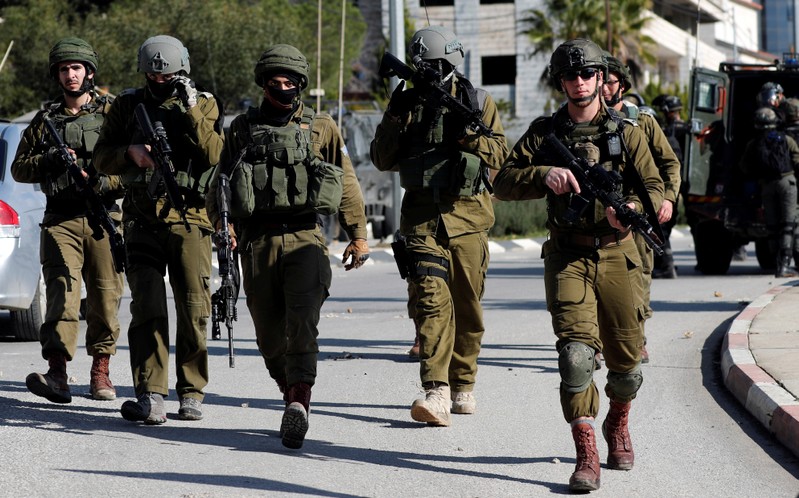 Israeli soldiers walk during clashes with Palestinians in Ramallah in the occupied West Bank