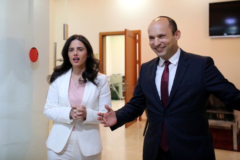 Israeli Education Minister Bennett and Justice Minister Shaked enter the room before delivering their statements in Tel Aviv