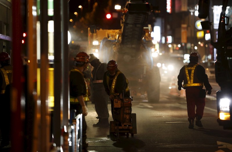 Workers resurface a public road in Tokyo, Japan