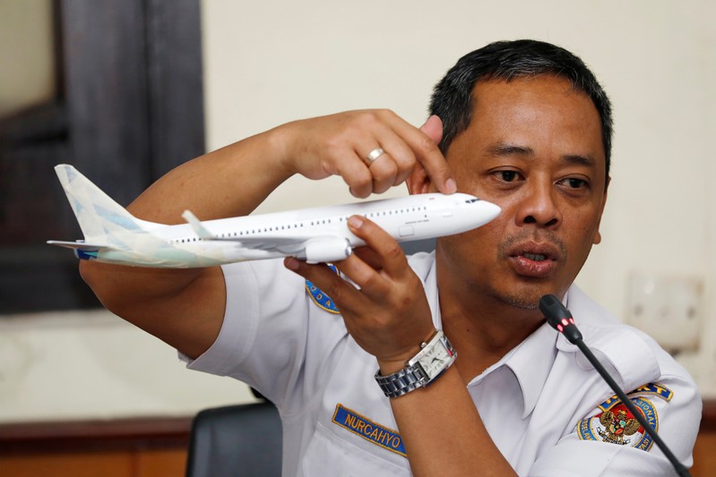 Indonesia’s National Transportation Safety Committee (KNKT) sub-committee head for air accidents, Nurcahyo Utomo, holds a model airplane while speaking during a news conference on its investigation into a Lion Air plane crash last month, in Jakarta