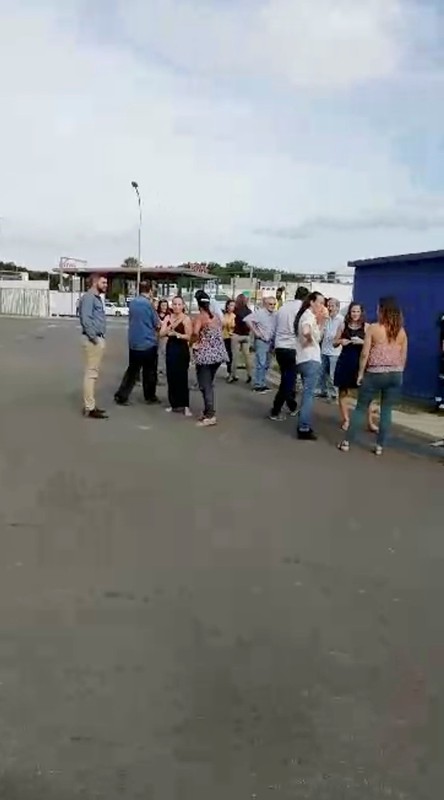 People gather outside during a quake evacuation in Noumea