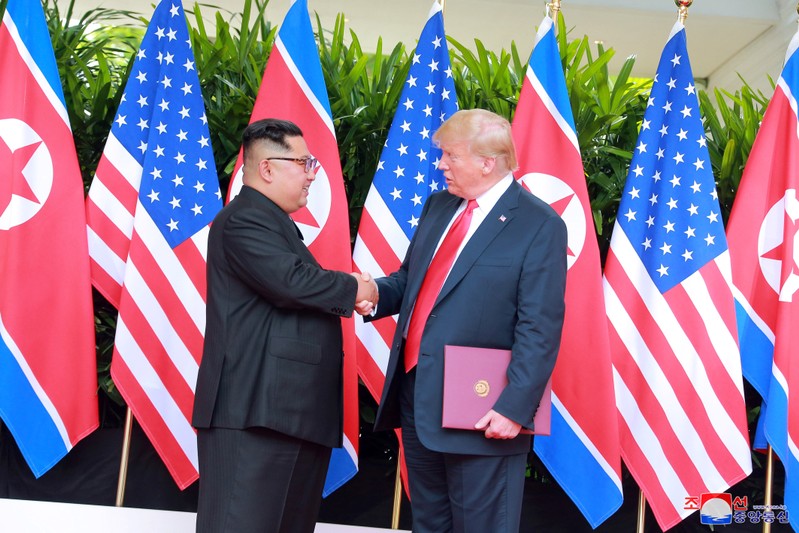 U.S. President Donald Trump shakes hands with North Korean leader Kim Jong Un at the Capella Hotel on Sentosa island in Singapore