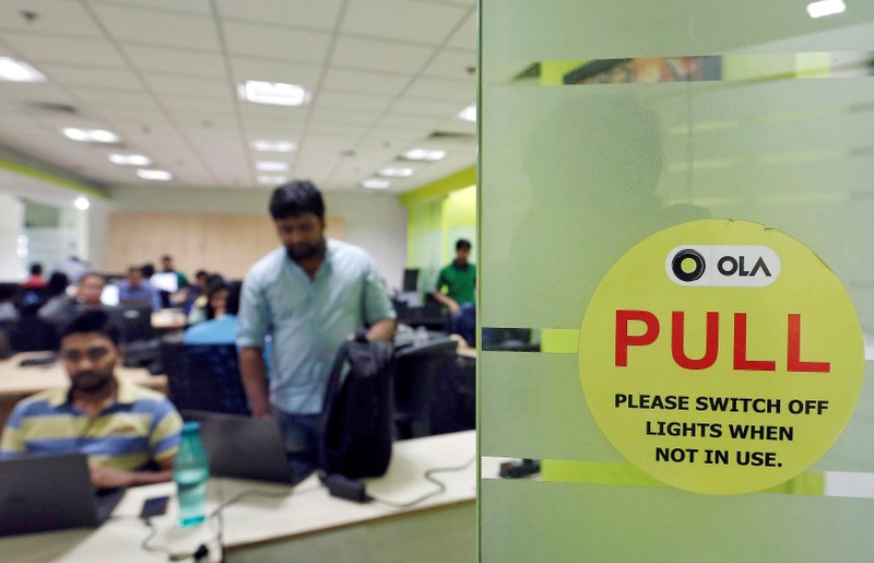 Employees work inside the office of Ola cab service in Gurugram