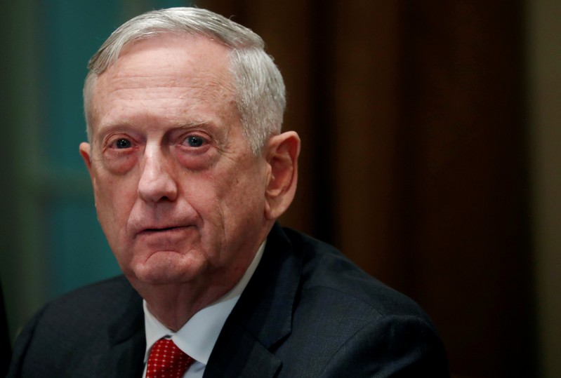 FILE PHOTO: U.S. Defense Secretary James Mattis listens as U.S. President Donald Trump speaks to the news media while gathering for a briefing from his senior military leaders in the Cabinet Room at the White House in Washington