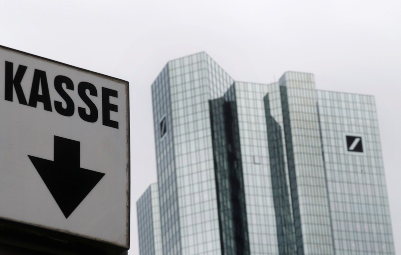 The cash desk sign of a nearby car park is pictured next to the head quarters of Germany's largest business bank, Deutsche Bank, in Frankfurt