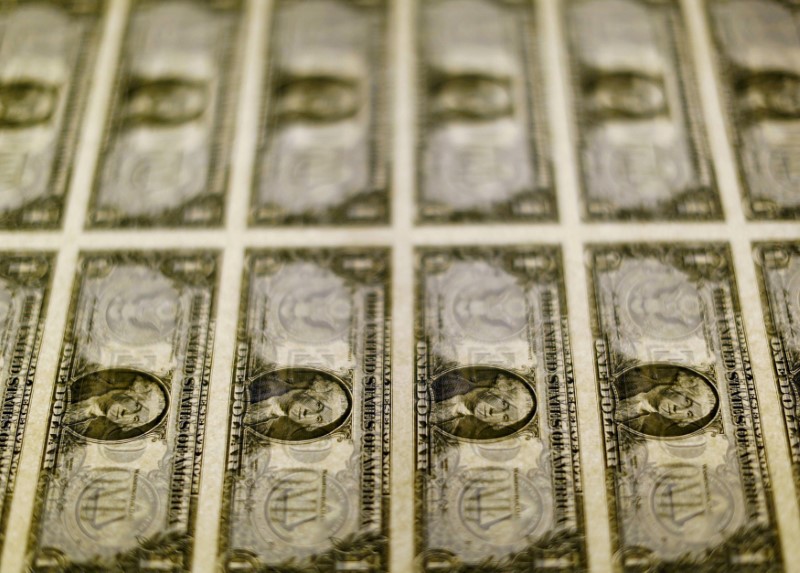 FILE PHOTO: United States one dollar bills seen on a light table at the Bureau of Engraving and Printing in Washington