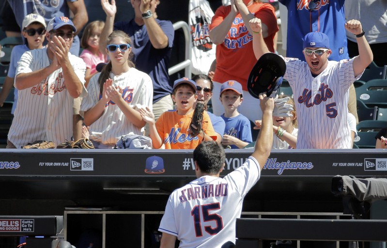 New York Mets catcher Travis d'Arnaud makes a curtain call for the fans after he hit a two-run home run against the Detroit Tigers in the fourth inning of their MLB inter-league baseball game at Citi Field in New York