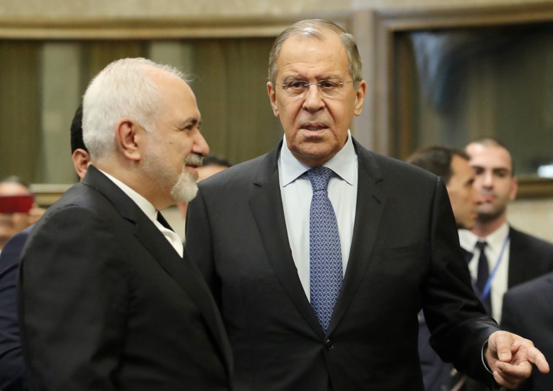 Russian Foreign Minister Sergei Lavrov and Iranian Foreign Minister Mohammad Javad Zarif are seen before a news conference after talks on forming a constitutional committee in Syria, at the United Nations in Geneva