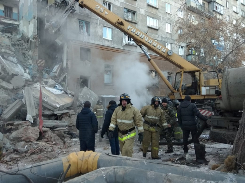 Emergency personnel work at the site of collapsed apartment building after a suspected gas blast in Magnitogorsk