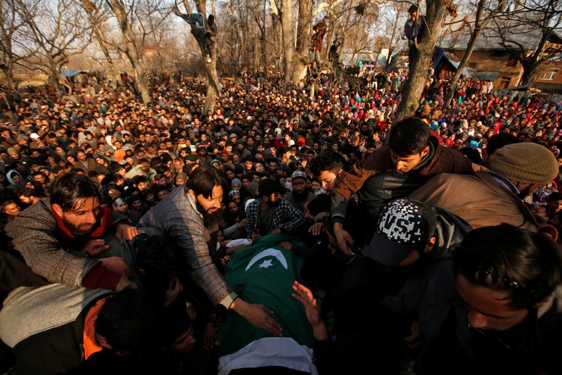 People gather around the body of Zahoor Ahmad, a suspected militant, during his funeral in Sirnoo village in south Kashmir's Pulwama district