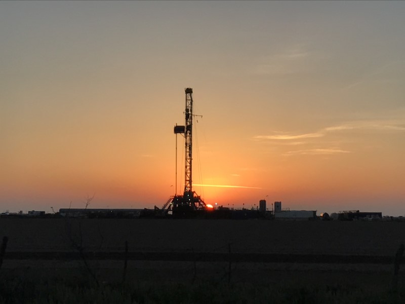 A drilling rig is seen at a well site owned by Parsley Energy Inc near Midland