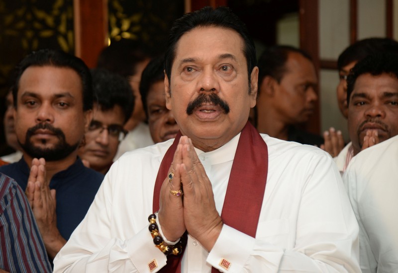 Sri Lanka's former leader Rajapaksa attends a religious ceremony after he resigned from PM post in Colombo